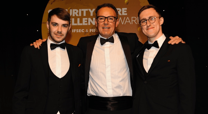 Fire and Security Apprentices Scott McNab (L) and Adam Smylie (R) celebrate winning in the Engineers of Tomorrow Intruders category at the Security and Fire Excellence Awards 2019 with Simon Banks, CSL Founder. 